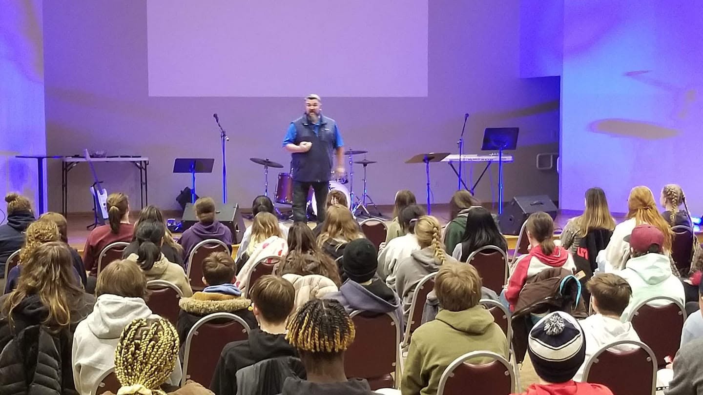 Tim Carmical speaking to a room filled with students